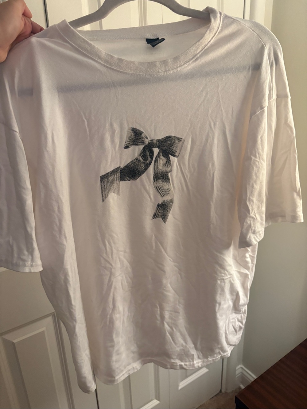 White woman’s  Crewneck T‑Shirt with Black Ribbon Graphic